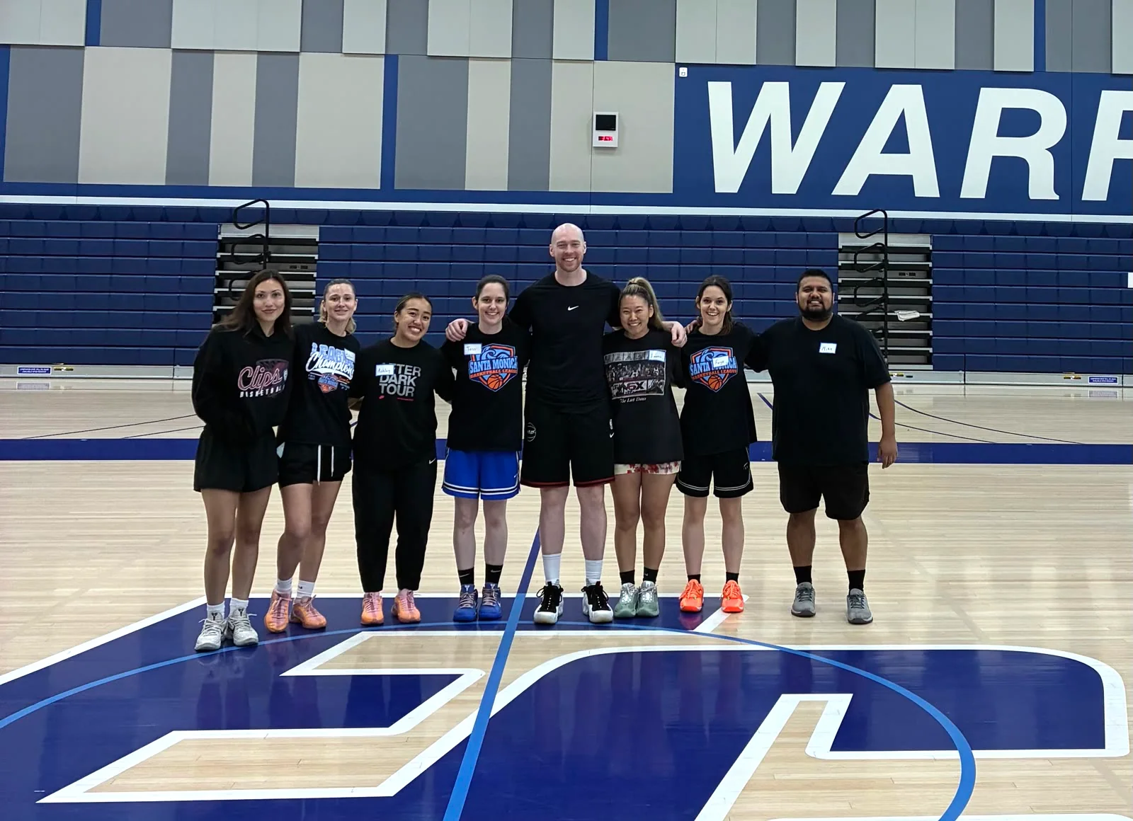 Adult basketball clinic group together on the court at El Camino College