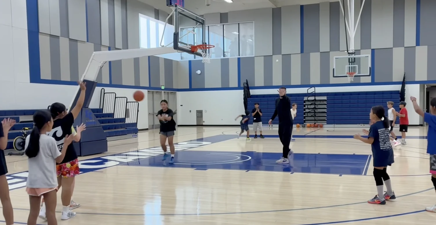 Youth basketball players and coach during an Open Gym session